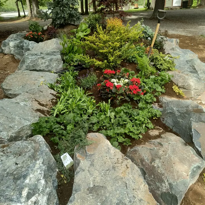 A planted boulder rockery marking a property entrance